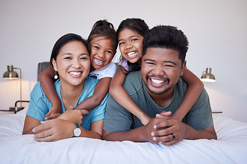Image showing Family, children and smile on bed for happy portrait together in house or bedroom. Mom, dad and kids in room, show love and happiness in while on holiday, vacation or own home in Jakarta, Indonesia