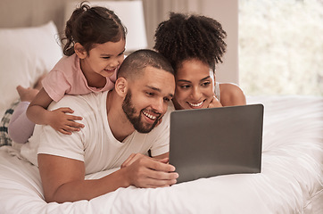 Image showing Internet, laptop and relax with family in bedroom after wake up to watch movies, search or streaming service. Technology, digital and smile with parents and girl at home with online subscription