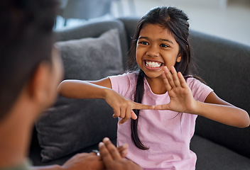 Image showing Child, sign language and learning to communicate with deaf girl or parent while making fingers and showing visual symbols at home. Happy kid with hearing disability or loss sitting with a tutor