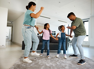 Image showing Family dancing, happy house and parents teaching children to dance, moving to music together and smile for love in home living room. Silly girl kids playing with fun mother and father in lounge