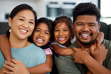 Image showing Family, smile and love of children for their mom and dad while sitting together in the lounge at home sharing a special bond. Portrait of happy Filipino man, woman and girl kids hugging their parents