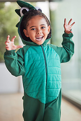 Image showing Child, halloween and playing role in costume in a living room at home and having fun being creative. Happy girl kid as fantasy dinosaur in character, smiling and excited to roar and play game