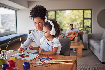 Image showing Family painting, relax music and mother helping her child with art, creative school work and learning with pain at table of home. Girl with headphones for audio using paint for education with mom