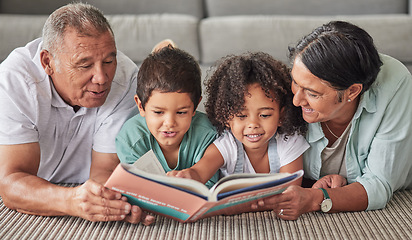 Image showing Family, book and children reading development growth at home with grandparents on the floor. Kids, elderly and happy people looking at books, story and pictures encourage fun learning and studying