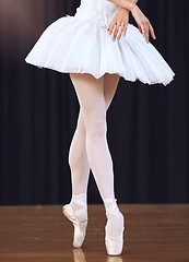 Image showing Ballet feet or legs dancing or training or practice in a dance studio, stage or class. Professional elegant dancer or ballerina in shoes for a performance or concert with classic music in a theater