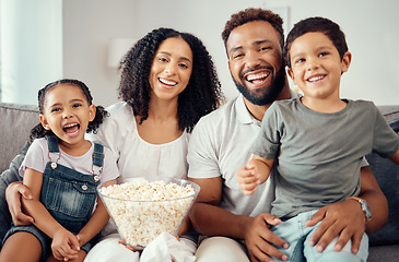 Image showing Love, laugh and watching tv or a movie with a happy family eating popcorn, having fun and smile together in home. Portrait of latino parents and children, enjoy the weekend and feeling carefree