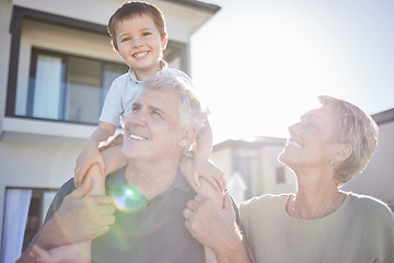 Image showing Children, family and love with a boy and his grandparents playing outside in the garden of their home during a visit. Kids, happy and senior with a male child on the shoulders of his grandfather