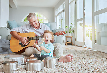 Image showing Child drummer with grandfather, guitar and music playing with pot drums in the living room at house. Happy, excited and smile of boy bonding and spending time with his elderly grandpa in family home.