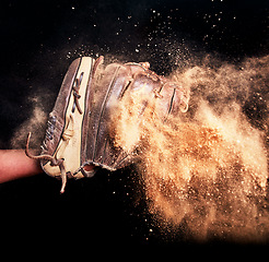 Image showing Baseball, game glove and dirt studio background for catch action in sports match. Isolated leather softball athlete equipment for score in tournament with black wall for mock up.