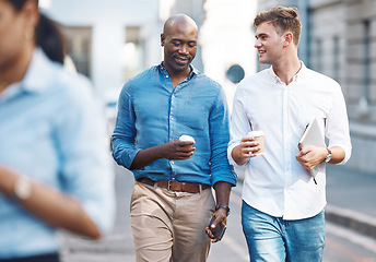 Image showing Men, walk and street with takeaway coffee while talk, smile and relax at lunch break. Black man, colleague and diversity in city at tea time, walking to office or workplace in discussion or talking