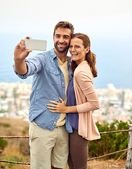 Image showing Couple, hug and selfie on phone, love and outdoors on vacation, laughing and memories for social media. Happy people, smartphone and adventure or technology, travel and humor on holiday, fun and joke