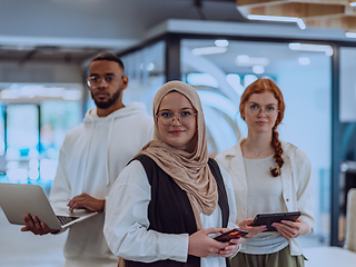 Image showing A diverse group of young business individuals is captured in a professional portrait at a modern office, reflecting their teamwork, ambition, and creativity in a vibrant and dynamic corporate setting