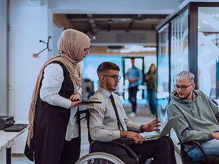 Image showing Young group of business people brainstorming together in a startup space, discussing business projects, investments, and solving challenges.