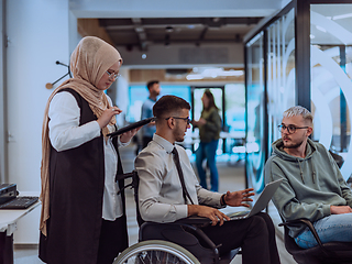 Image showing Young group of business people brainstorming together in a startup space, discussing business projects, investments, and solving challenges.