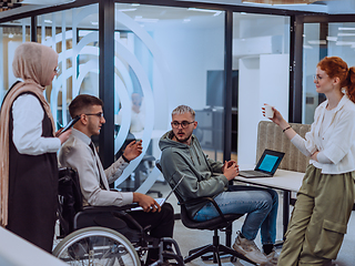 Image showing Young group of business people brainstorming together in a startup space, discussing business projects, investments, and solving challenges.