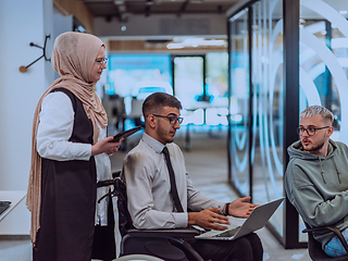 Image showing Young group of business people brainstorming together in a startup space, discussing business projects, investments, and solving challenges.