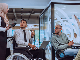 Image showing Young group of business people brainstorming together in a startup space, discussing business projects, investments, and solving challenges.