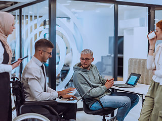 Image showing Young group of business people brainstorming together in a startup space, discussing business projects, investments, and solving challenges.