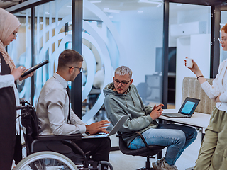 Image showing Young group of business people brainstorming together in a startup space, discussing business projects, investments, and solving challenges.