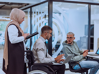 Image showing Young group of business people brainstorming together in a startup space, discussing business projects, investments, and solving challenges.