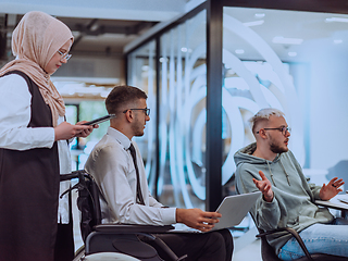 Image showing Young group of business people brainstorming together in a startup space, discussing business projects, investments, and solving challenges.