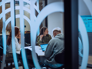 Image showing A diverse group of businessmen collaborates and tests a new virtual reality technology, wearing virtual glasses, showcasing innovation and creativity in their futuristic workspace