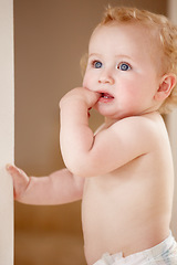 Image showing Face, hands and baby in a room for playing, watching or fun, learning, walk or balance. Little, child development and curious boy kid in a nursery playful, standing and enjoy youth, freedom or games