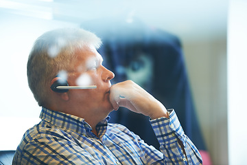 Image showing Senior businessman, headphones and thinking at call center for decision, choice or customer service at office. Mature man, consultant or agent in wonder or thought for online advice or help workplace