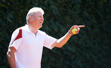 Image showing Happy, senior man and game of tennis on court for exercise, workout and training in sport. Hand, pointing and mature person smile with energy, fitness and playing in healthy competition in retirement