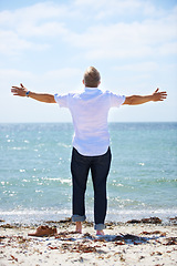 Image showing Beach, back and senior man with open arms freedom in nature for travel, adventure or celebration. Ocean rear view an elderly male person with retirement vacation at the sea with gratitude in Bali