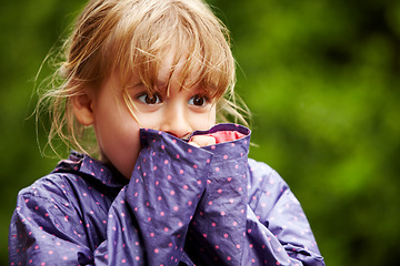 Image showing Child, play and outdoor nature in raincoat for winter youth fun, explore or travel in cold weather. Young girl, happy or excited or relax holiday on vacation break as wet game or joy, surprise as kid