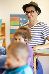 Image showing Kindergarten, teacher and happy man in class with kids or thinking about montessori, education and learning. Children, school and teaching volunteer sitting in classroom with inspiration and ideas