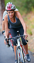 Image showing Cycling, fitness and portrait of woman on a bicycle in road for training, wellness or sports race. Health, exercise or face of lady athlete on a bike for morning cardio, workout or marathon challenge