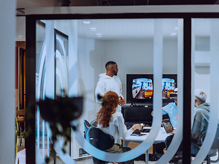 Image showing A diverse group of businessmen collaborates and tests a new virtual reality technology, wearing virtual glasses, showcasing innovation and creativity in their futuristic workspace