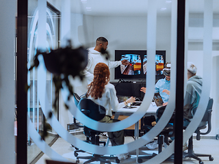 Image showing A diverse group of businessmen collaborates and tests a new virtual reality technology, wearing virtual glasses, showcasing innovation and creativity in their futuristic workspace