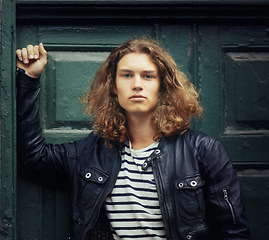 Image showing Man, portrait and serious outdoor for fashion, urban style and edgy outfit with confidence and pride. Person, face and young model with casual jacket, long hairstyle and stylish with calm expression