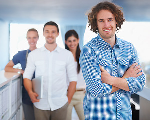 Image showing Smile, crossed arms and portrait of businessman with team in the office for management with confidence. Happy, success and young male manager from Canada with employees working in modern workplace.