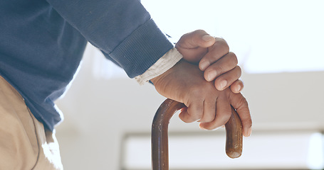 Image showing Cane, hands and senior man in home living room for retirement in house. Walking stick, closeup and elderly person with a disability, crutch for injury and support, help for health and osteoporosis