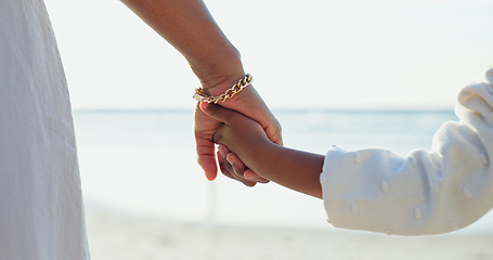 Image showing Woman, child or holding hands for love by beach or bonding together for happiness on summer vacation. Commitment, mother or kid in support relationship, holiday or relax wellness by calm ocean