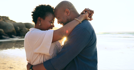 Image showing Couple, hug and happy on beach with love, bonding and sunset for holiday, vacation and relationship. Black people, man or woman with embrace, smile and romance by ocean or sea for travel or adventure