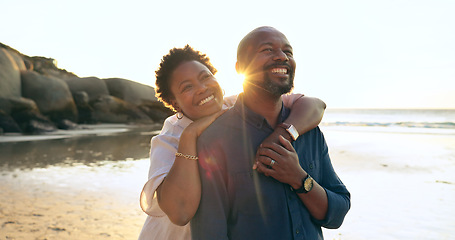 Image showing Couple, hug and happy on beach with love, bonding and sunset for holiday, vacation and relationship. Black people, man or woman with embrace, smile and romance by ocean or sea for travel or adventure