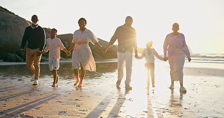 Image showing Family, fun and holding hands at beach, support and unity or trust, ocean and solidarity or care. Happy black people, sea and love or joy, bonding or water on vacation, holiday and laughing at sunset