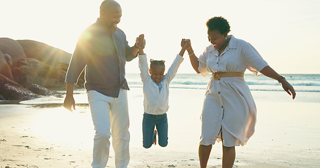 Image showing Parents, holding hands and swing child on beach for vacation, holiday and fun game at sunset. Happy family, play and relax together at the sea, ocean and playing on sand with trust, support and care