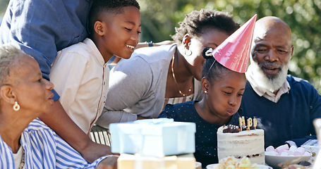 Image showing Child, cake or black family in nature for a happy birthday, celebration or support with grandparents. Candles, blow or excited African people with gift, love or kids in a fun party, backyard or park