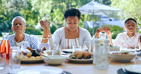 Image showing Holding hands, black family or kid praying for food to worship God together for faith or gratitude. Grandmother, backyard or African mom with child in nature for a meal, brunch or lunch with grace