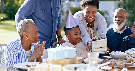 Image showing Backyard, birthday and party with black family, celebration and singing with joy, event and happiness. Grandparents, mother and father with children, kids and present with love, cake and outdoor