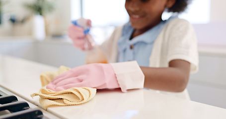 Image showing Happy girl, hands and cleaning table for housekeeping, hygiene or disinfection in chores at home. Closeup of female person, child or kid wipe surface, furniture or kitchen in bacteria or germ removal
