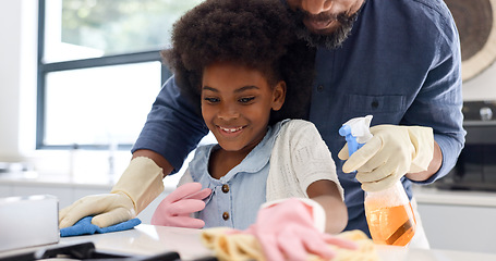 Image showing Happy black girl, father and cleaning in kitchen together for hygiene, housekeeping or bonding in chores at home. African dad and child wiping surface, furniture or table for germ or bacteria removal