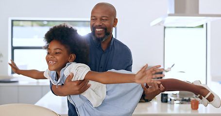 Image showing Child, father and happy with airplane game in kitchen, freedom and fun with love bonding in home. Black family, playing or fantasy flying with arms in air, young daughter or trust together in house