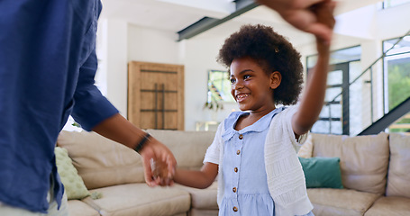 Image showing Black family, dance or love with a father and daughter together on holiday in home living room. Smile, music or happy girl child holding hands with parent to relax in the house for fun celebration
